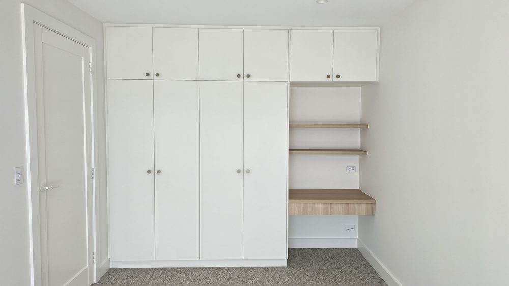 White built-in wardrobe with open shelving and hanging space