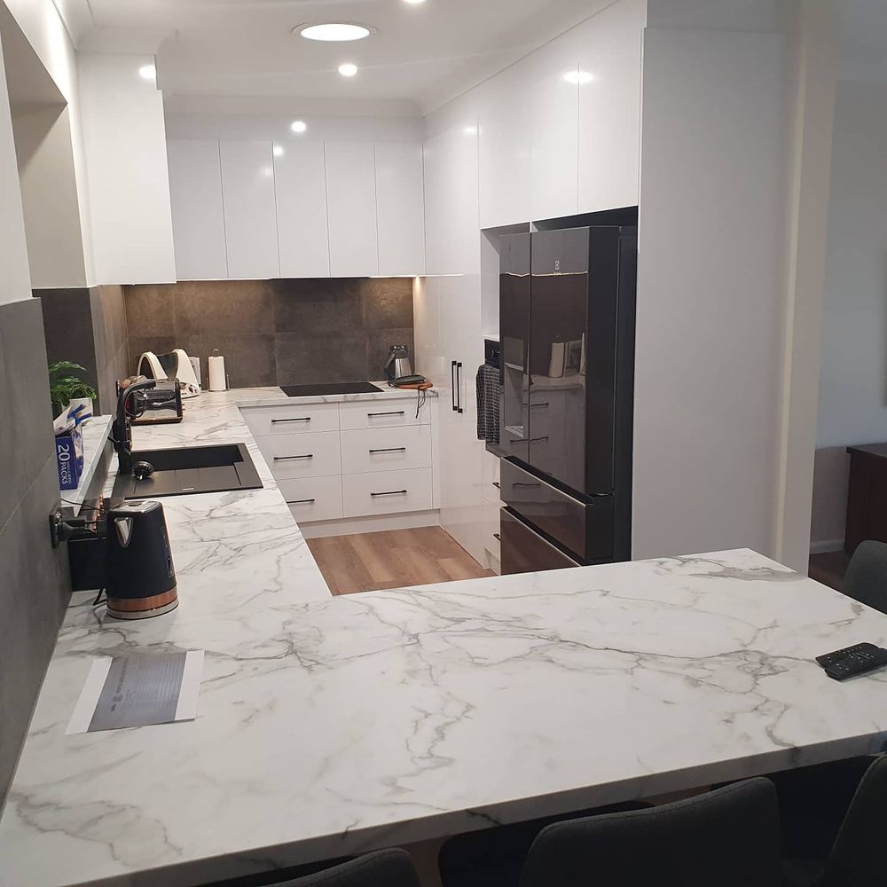 Open-plan kitchen with marble island bench and dining space