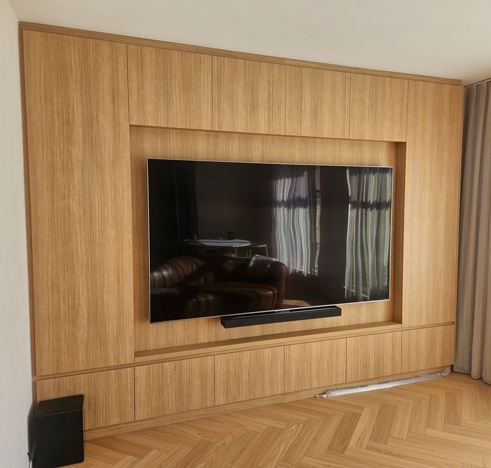 Timber entertainment wall with a recessed TV and slatted timber panelling