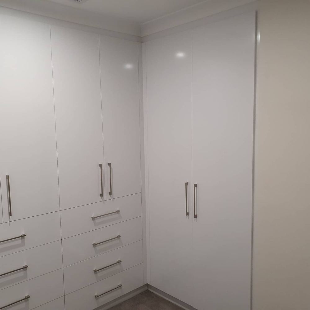 White built-in robes with central drawer bank